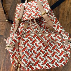 Chic Patterned Backpack with Tan and Red Accents